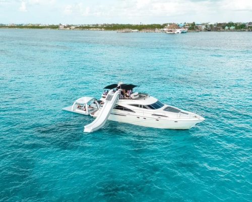 Aerial view of the Fairline 65 yacht with water slide in turquoise Caribbean waters